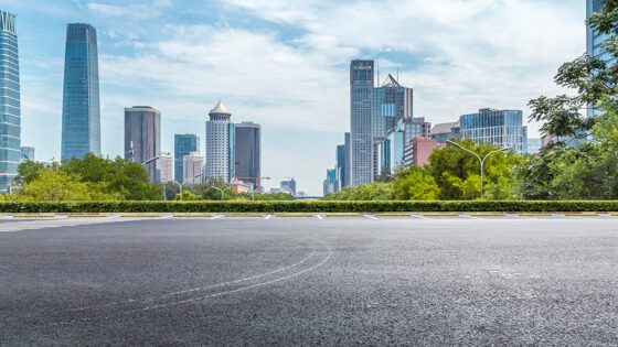 A road and parking lot are added next to businesses.