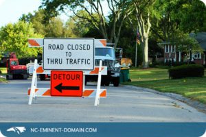 Detour sign due to road construction in a residential neighborhood.