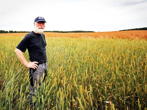 Famer smiling in a field.