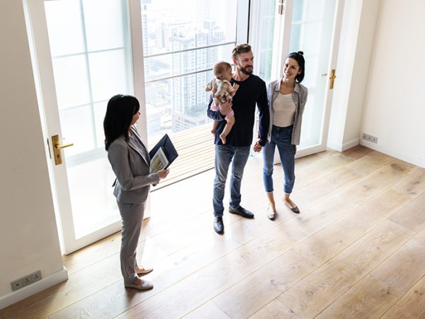 Family taking a house tour with a real estate agent.